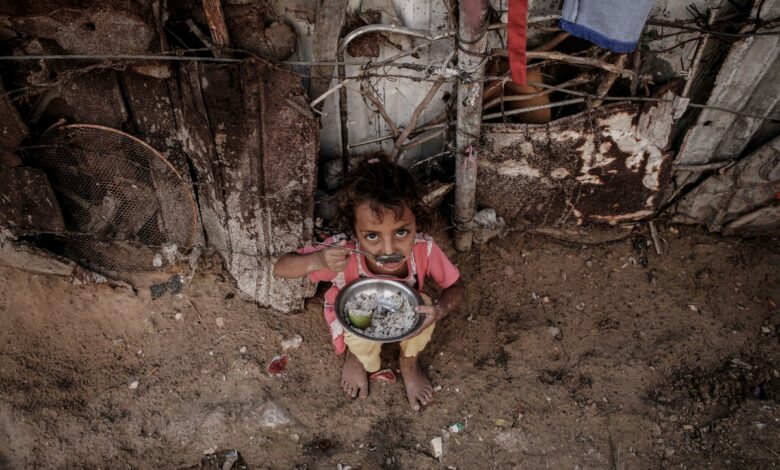 2013 2 2 a palestinian girl eats outside her familys in a poverty strickenezz 00 3