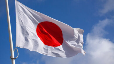 japan flag waving in the wind against blue sky