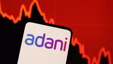 illustration shows adani logo decreasing stock graph