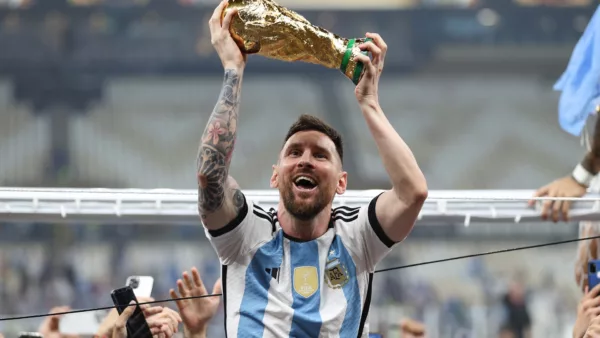Forbes 2023 list Messi holding the FIFA Cup