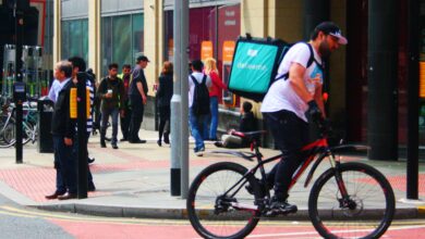 deliveroo cyclist on a bike in manchester